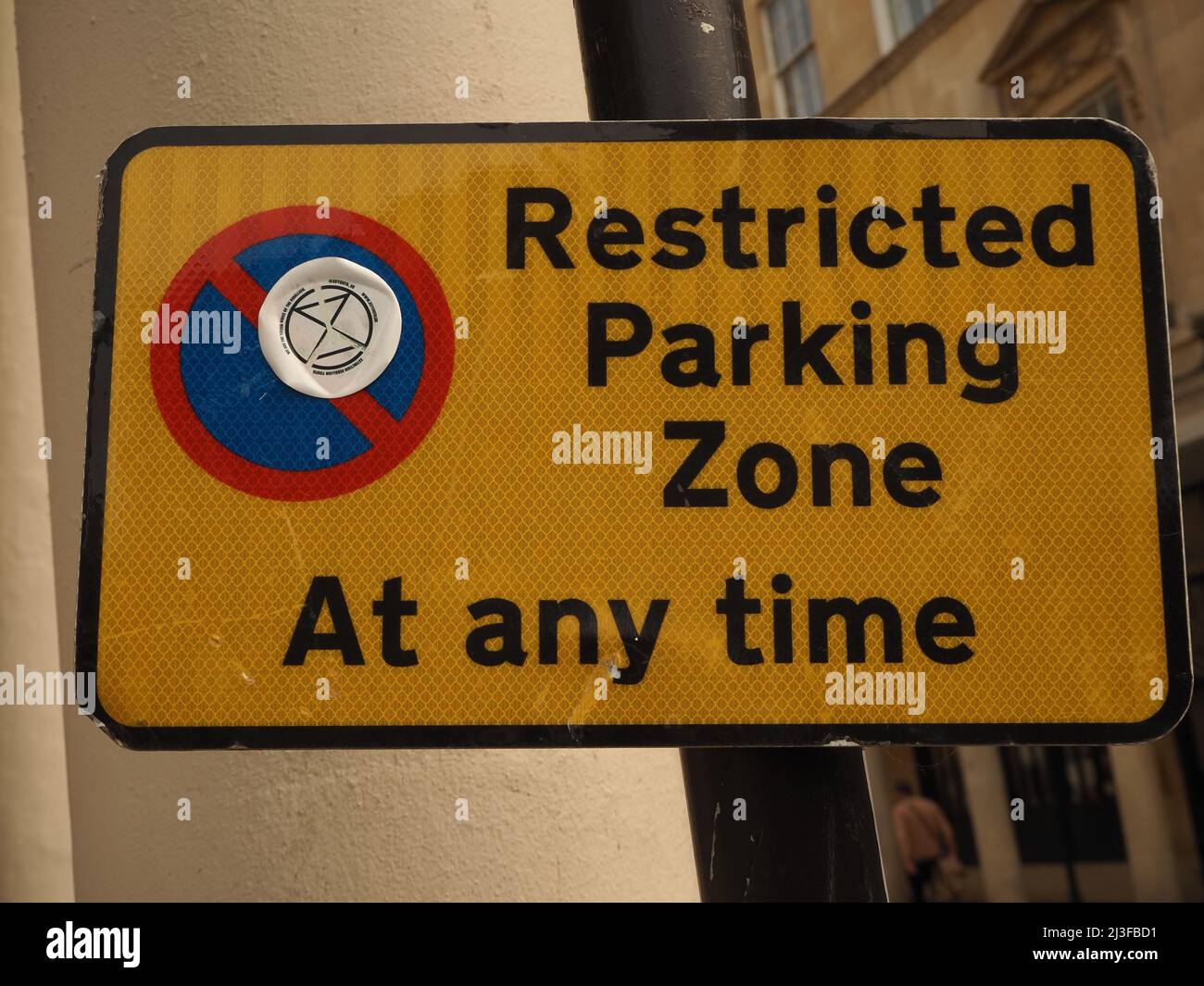 Restricted parking zone sign, with Extinction Rebellion Youth sticker, Bath, Somerset March 2022. Stock Photo