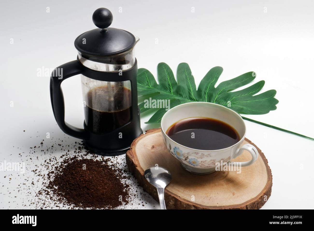 photo studio of french press coffee with cup of coffee spoon and coarse
