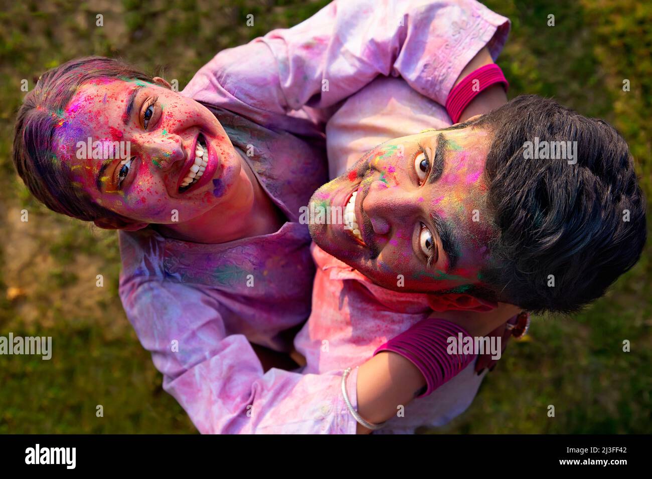 Overhead view of a romantic young couple enjoying Holi Stock Photo ...