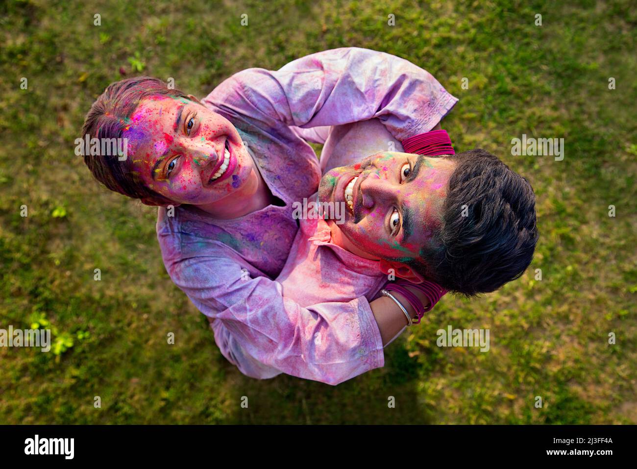 Overhead view of a romantic young couple enjoying Holi Stock Photo ...