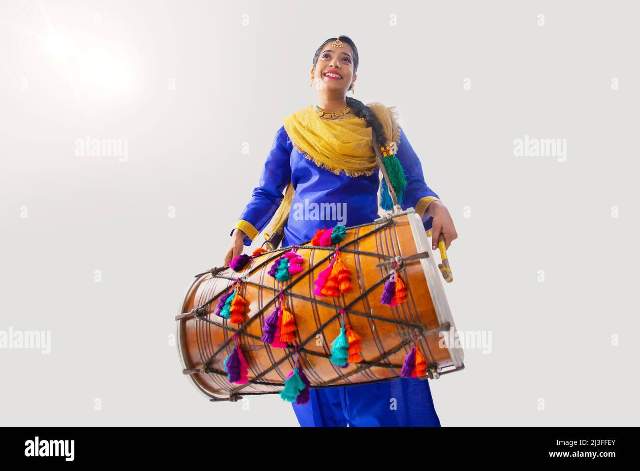 Portrait of Sikh woman playing drum during Baisakhi celebration Stock Photo