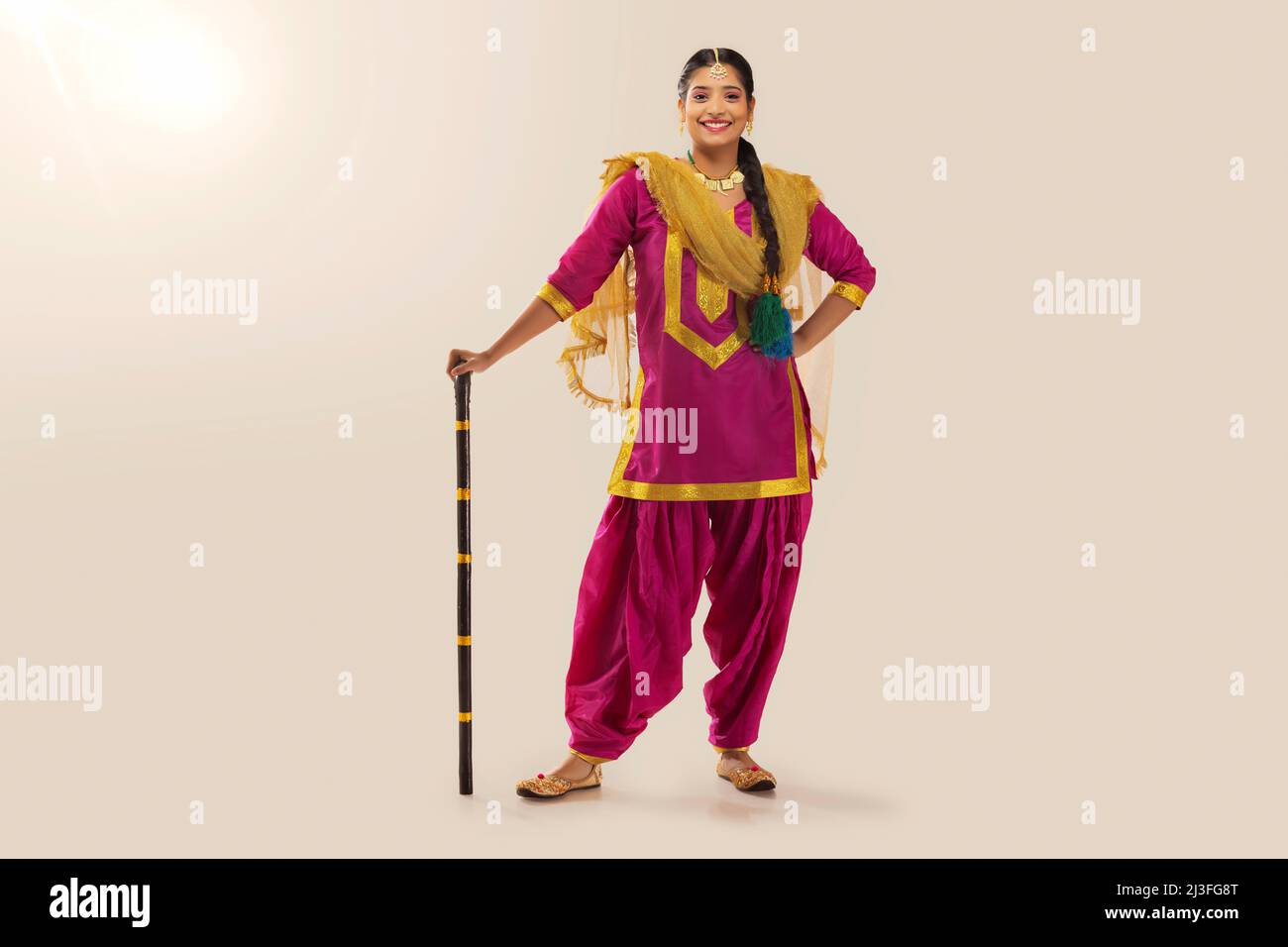 Portrait of Sikh woman in traditional outfit standing with khunda Stock