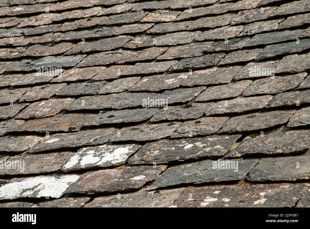 Old stone slade tiles roof closeup as stone background Stock Photo
