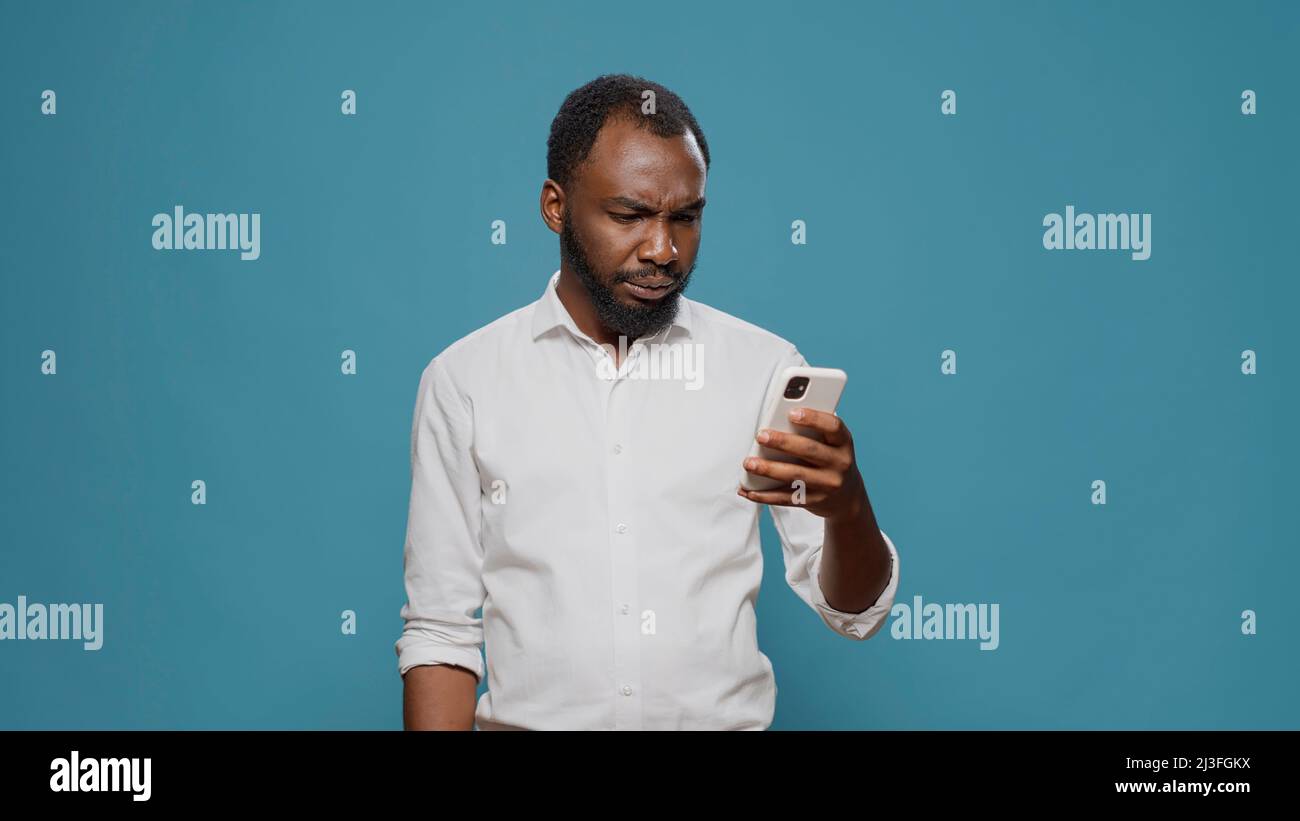 Happy man reading good news on smartphone and celebrating success ...