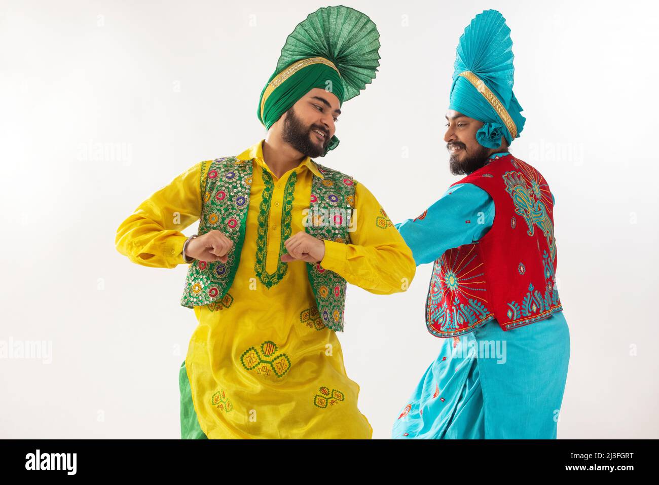 Sikh men performing bhangra together during Baisakhi celebration Stock Photo