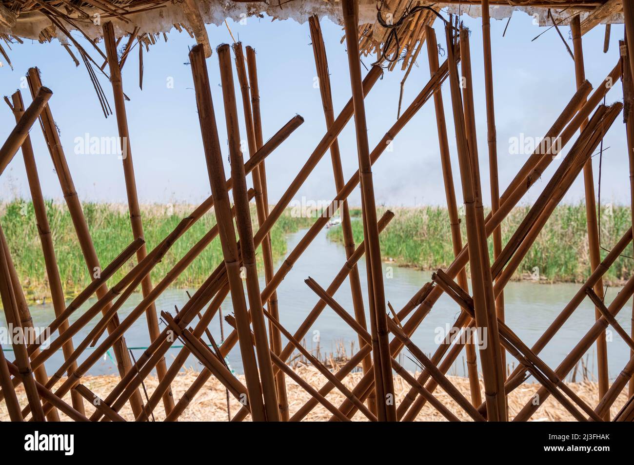 Looking through the reed-built walls of a traditional house in the Chibayish Marsh in southern Iraq Stock Photo