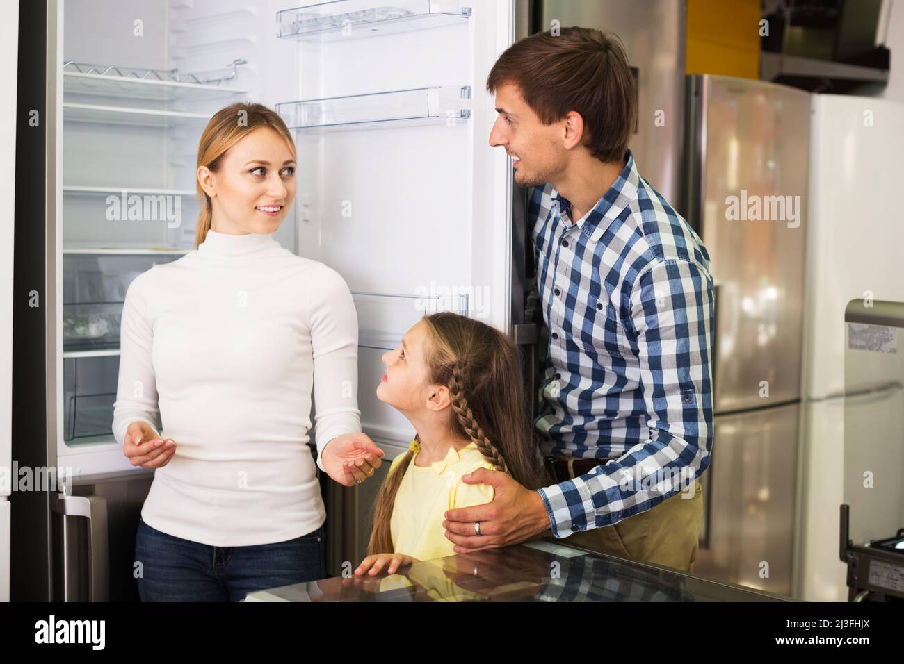 Family choosing refrigerator in store Stock Photo