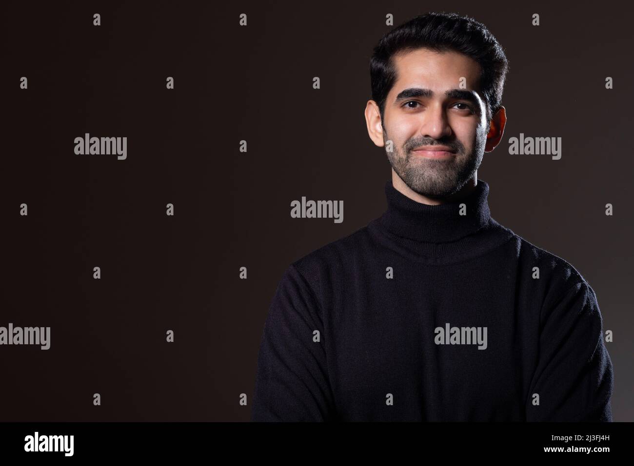 Portrait of a handsome young man looking at the camera Stock Photo - Alamy