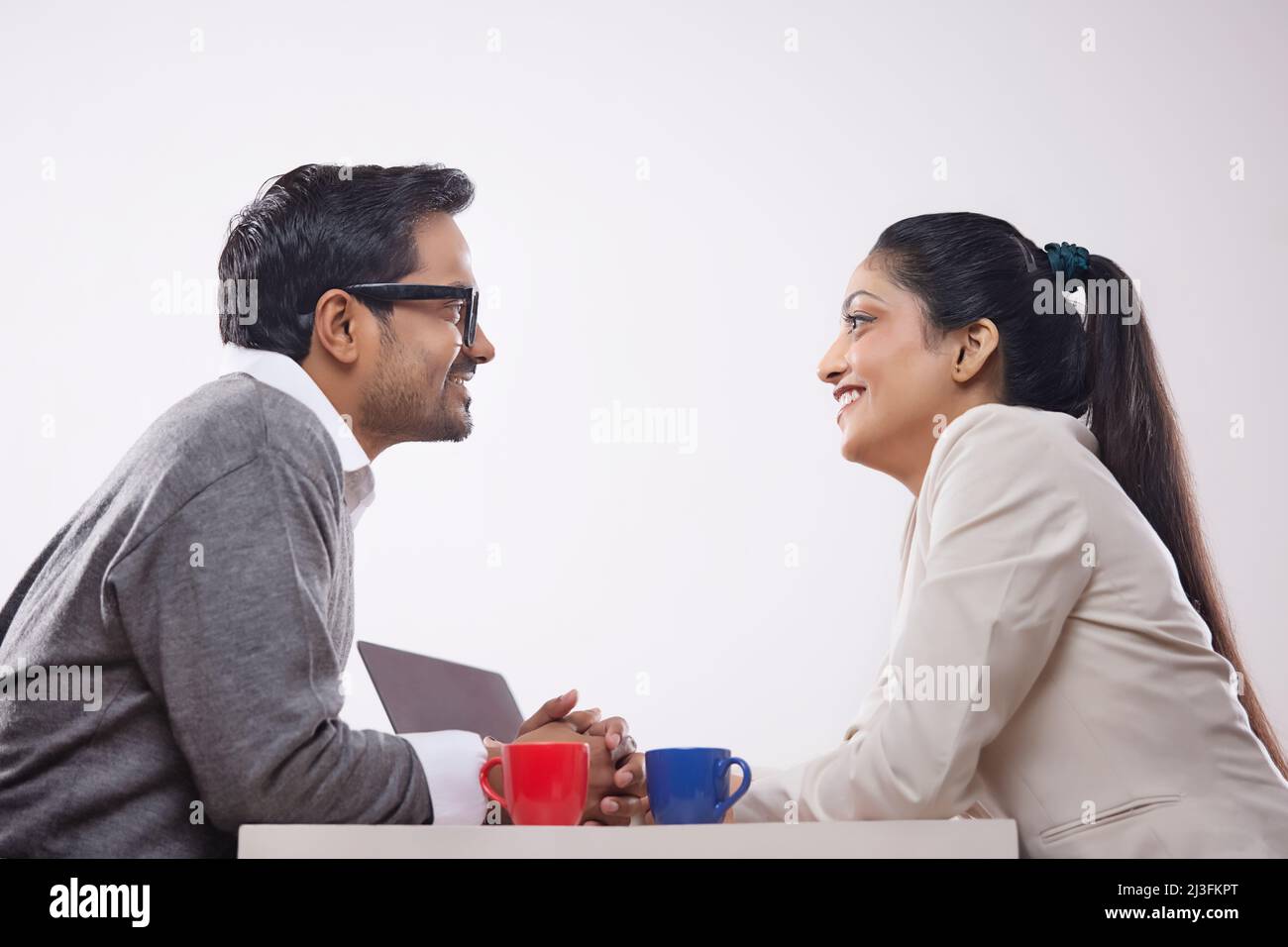 Portrait of a business young man and woman talking each other Stock ...