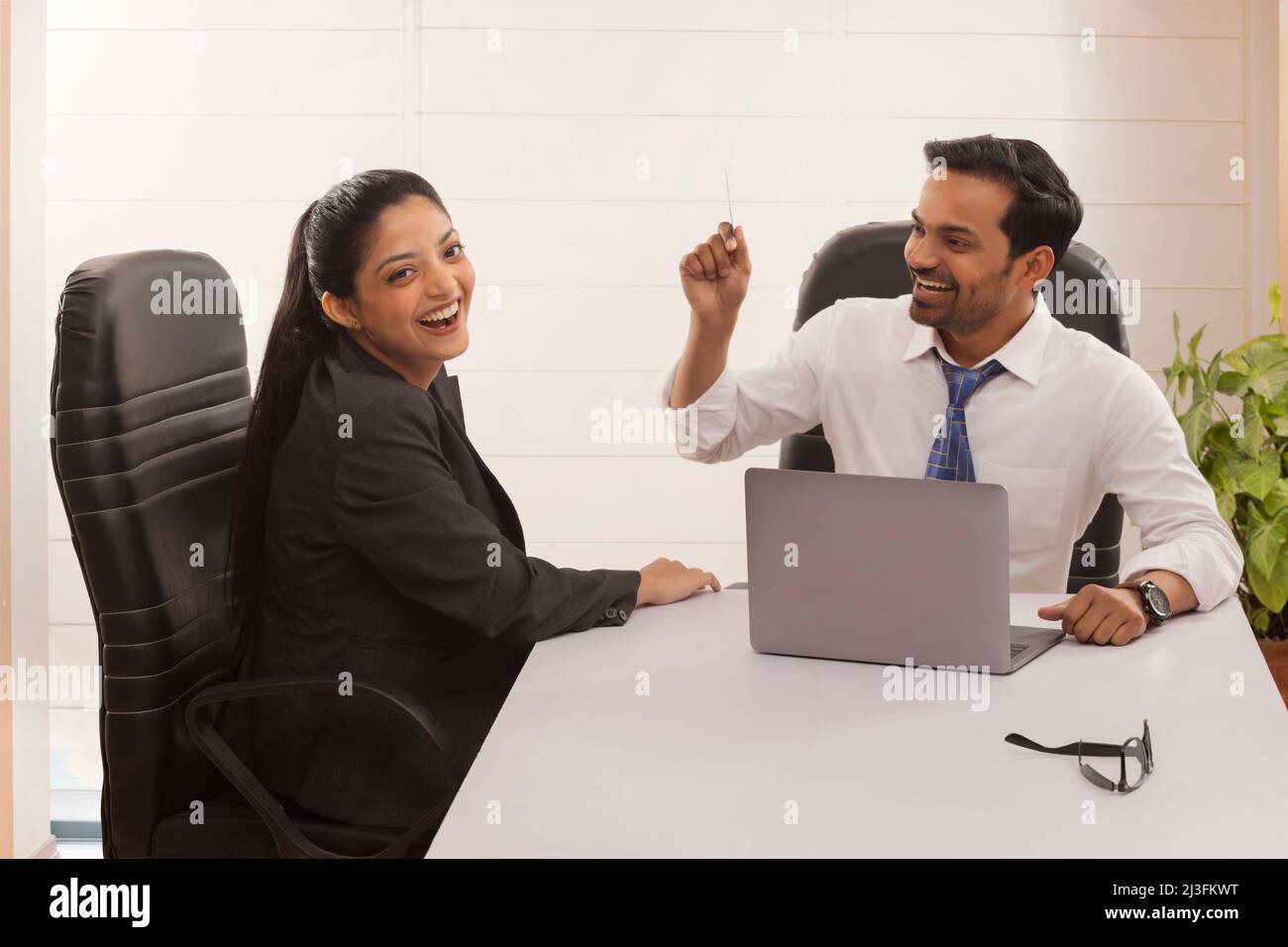 Happy business couple cheering after successful transaction using credit card Stock Photo