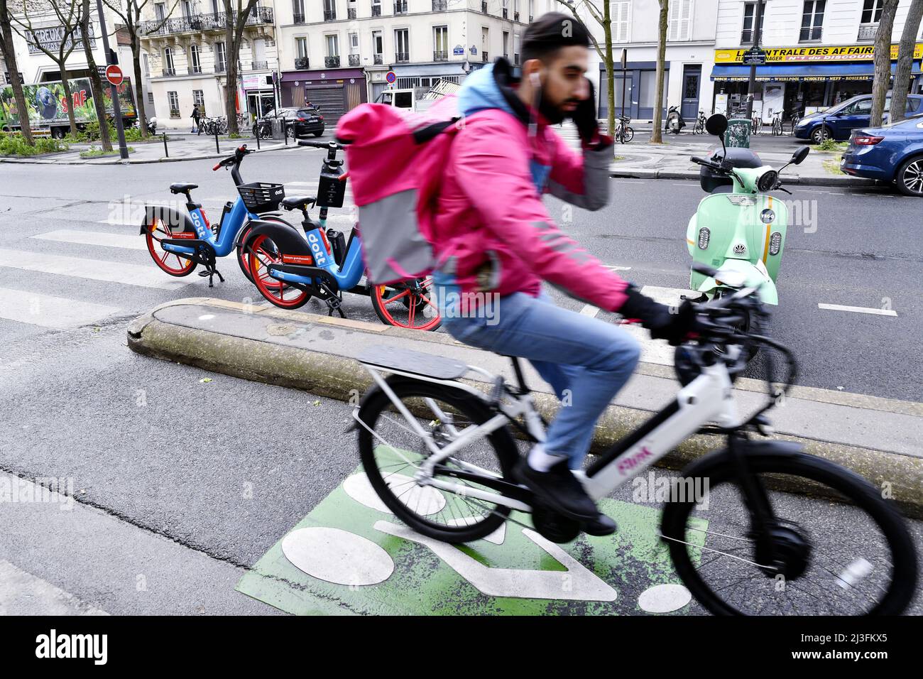 Food delivery biker on a track - Paris - France Stock Photo