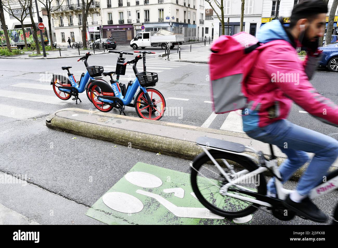 Food delivery biker on a track - Paris - France Stock Photo