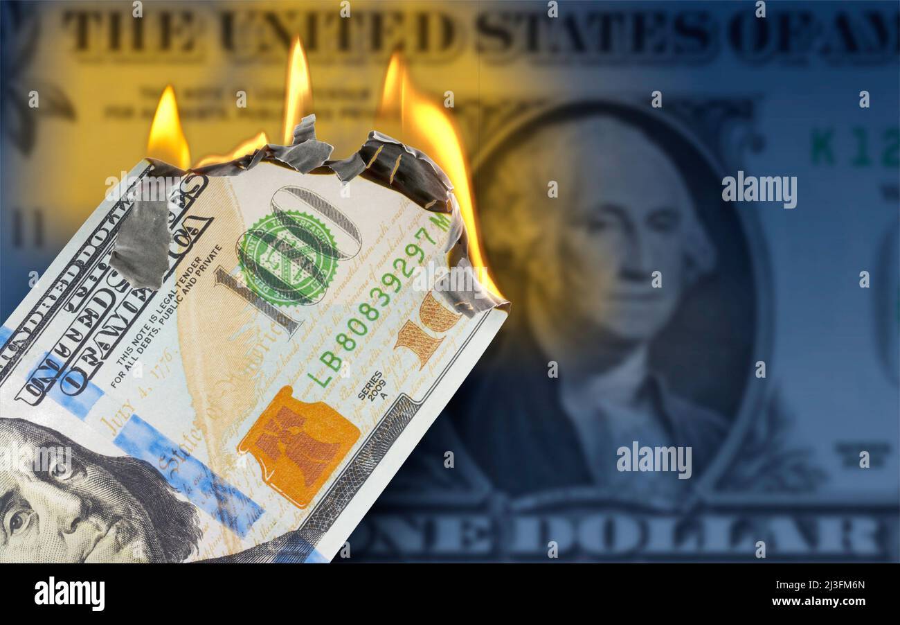 A burning 100 US dollar bill in front of One Dollar banknote Stock Photo