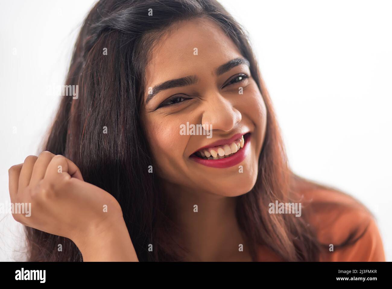 Close-up portrait of smiling woman with long black hair Stock Photo