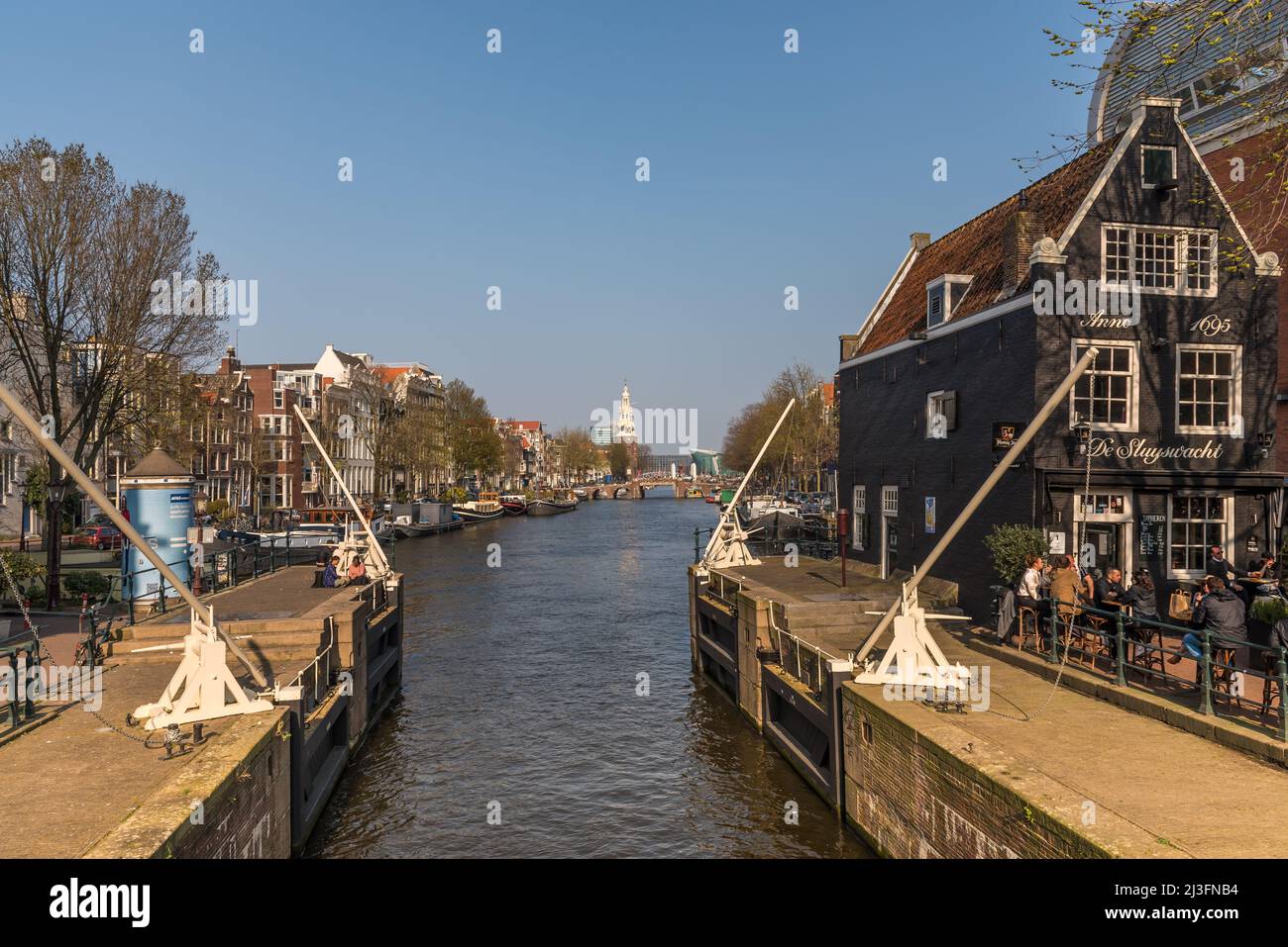 Amsterdam, Netherlands, April 2022. The St. Antonie lock and the Munttoren in Amsterdam. High quality photo Stock Photo