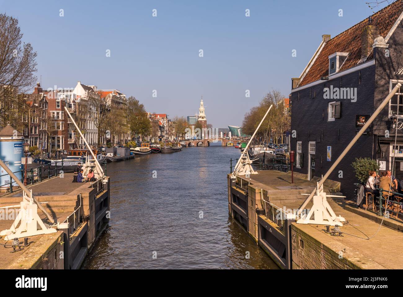 Amsterdam, Netherlands, April 2022. The St. Antonie lock and the Munttoren in Amsterdam. High quality photo Stock Photo