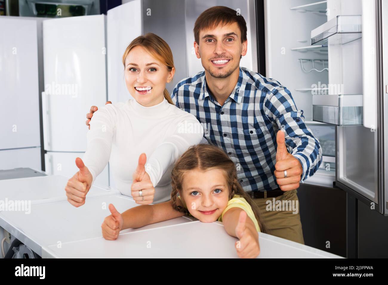 Family choosing refrigerator in store Stock Photo