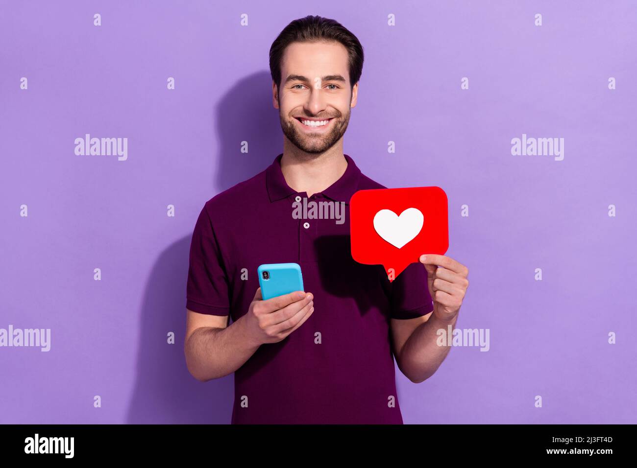 Photo of funny positive young man influencer receive many likes on social  media isolated on purple color background Stock Photo - Alamy