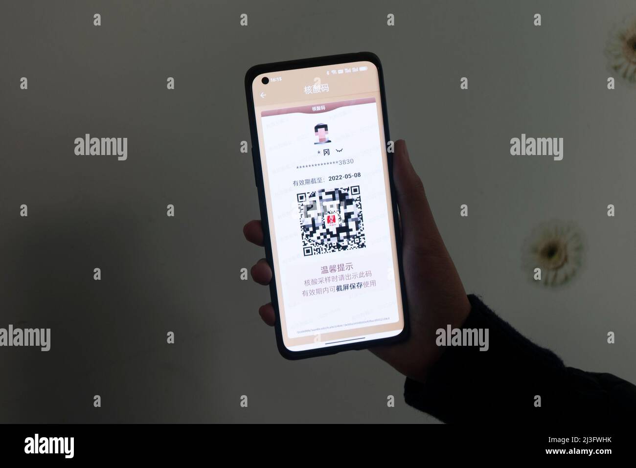 SHANGHAI, CHINA - APRIL 8, 2022 - A citizen holds a mobile phone to display  the nucleic acid code obtained from the citizen cloud app in Shanghai,  China, April 8, 2022. It