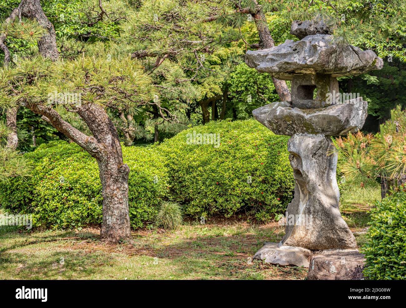 Stone lantern at the Japanese Garden at Shinjuku Gyoen National Garden, Tokyo, Japan Stock Photo