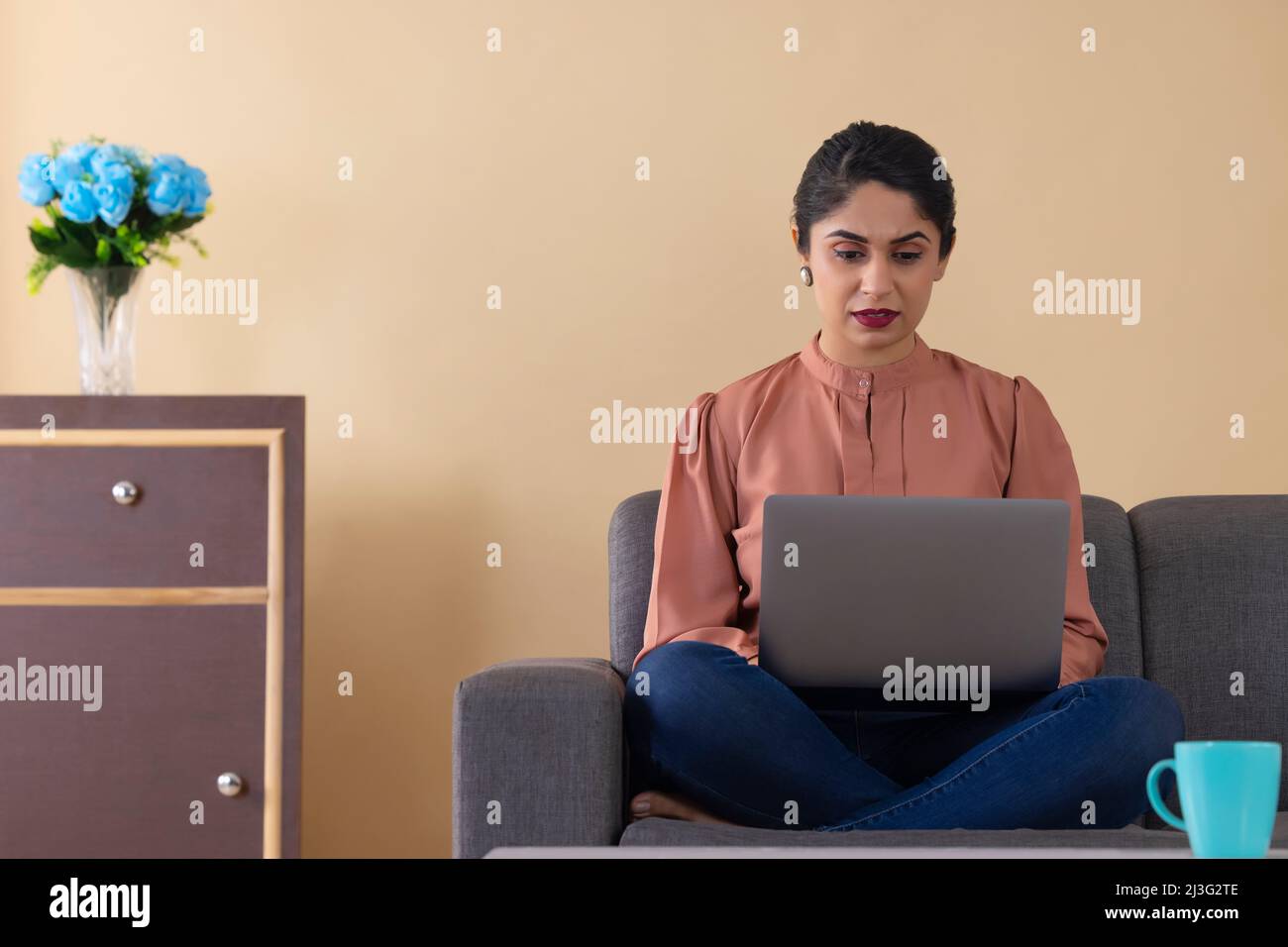 Indian woman working from home using laptop Stock Photo