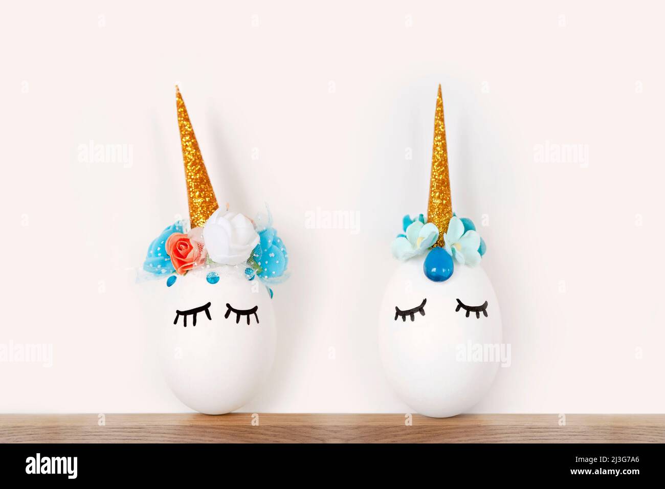Funny pair of decorative unicorn shaped white egg.Spring Holiday Crafts Kids Concept. Greeting Card Poster Banner. Stock Photo