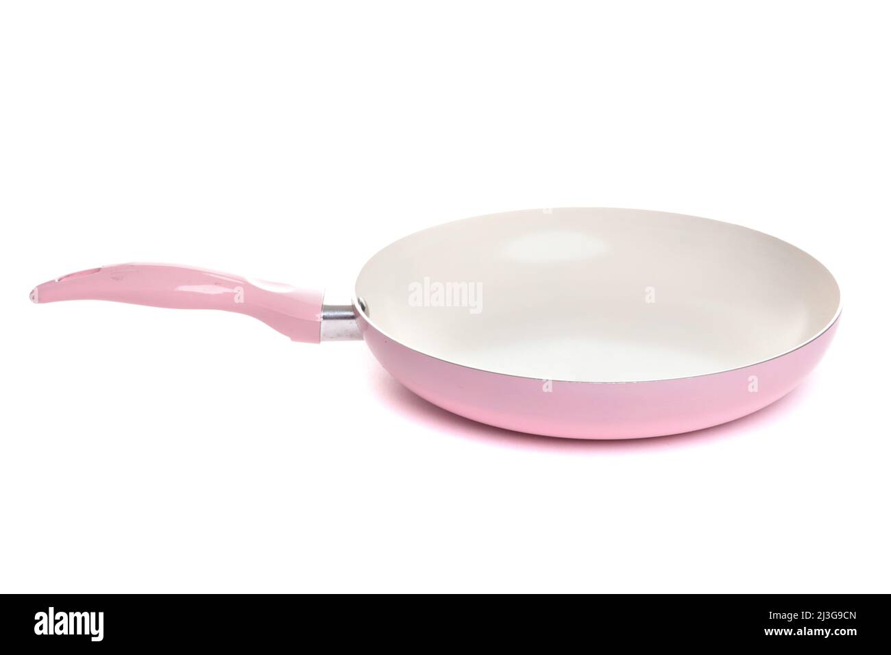 frying pan of pink color with white non-stick coating on an isolated  background Stock Photo - Alamy
