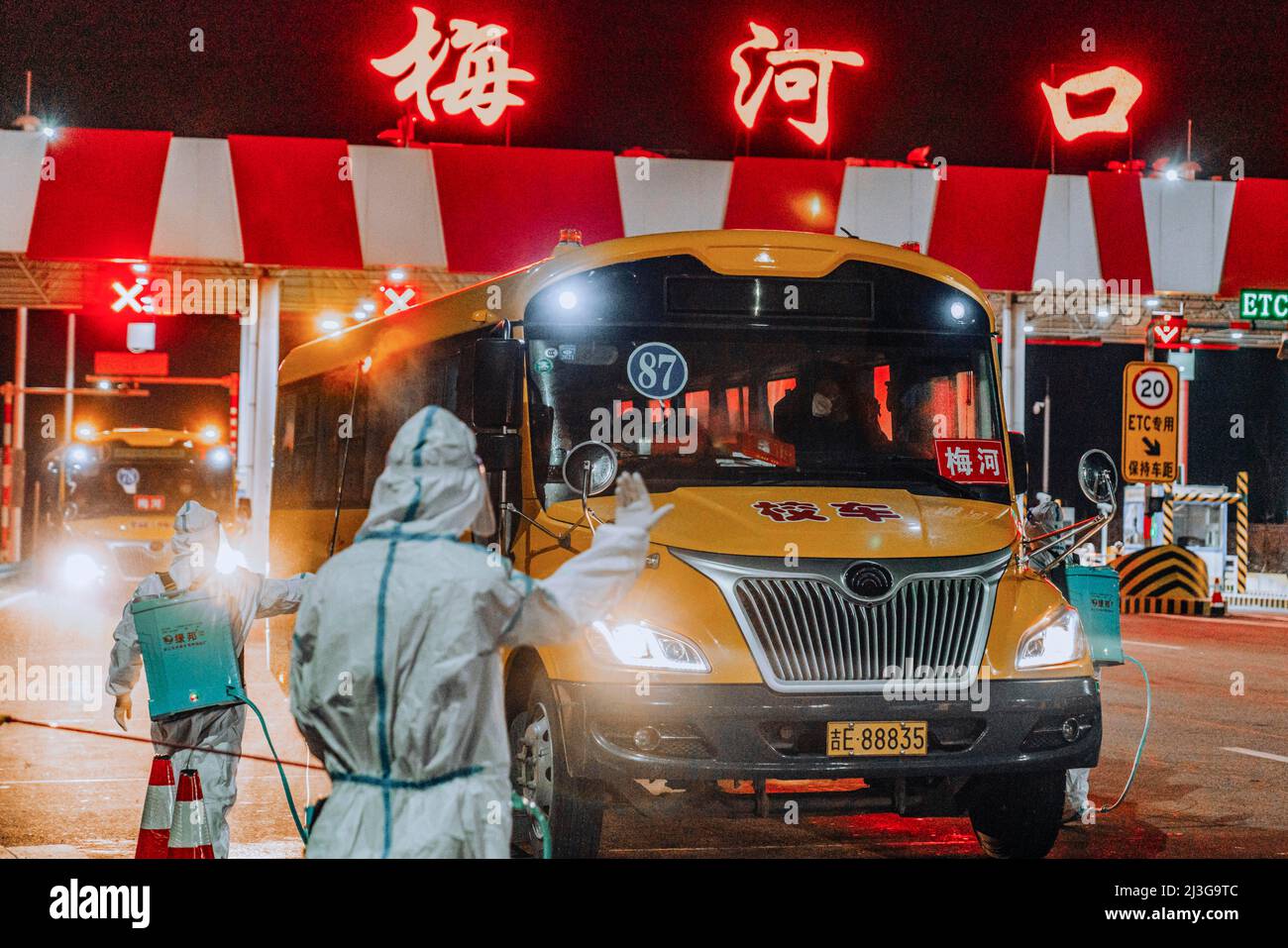 (220408) -- CHANGCHUN, April 8, 2022 (Xinhua) -- Staff members disinfect school buses transporting supportive team members from Changchun in Meihekou City, northeast China's Jilin Province, April 3, 2022. Some 5,000 supportive staff from Meihekou City who are aiding Changchun, one of the hardest-hit cities in China amid the latest virus resurgence, commute between the two cities every day in order to lessen boarding and lodging burdens on Changchun. The supportive team members, including medics, government officials and police officers, start off early morning and get back in late night, both Stock Photo