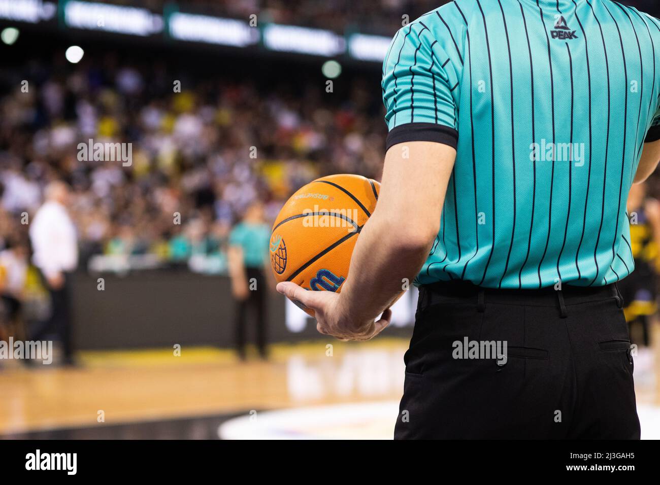 referee holding Champions League basketball during game Stock Photo Alamy