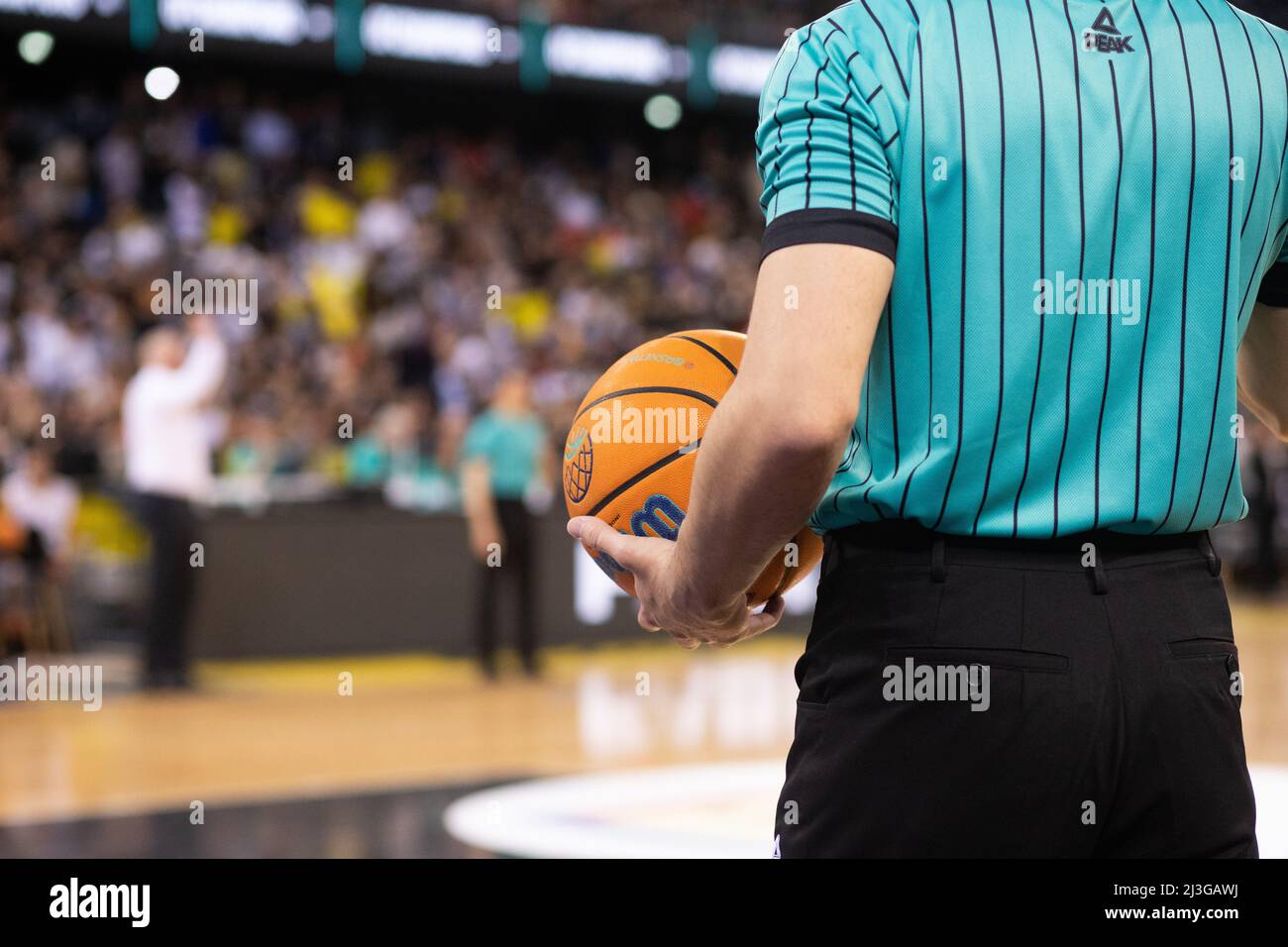 referee holding Champions League basketball during game Stock Photo Alamy