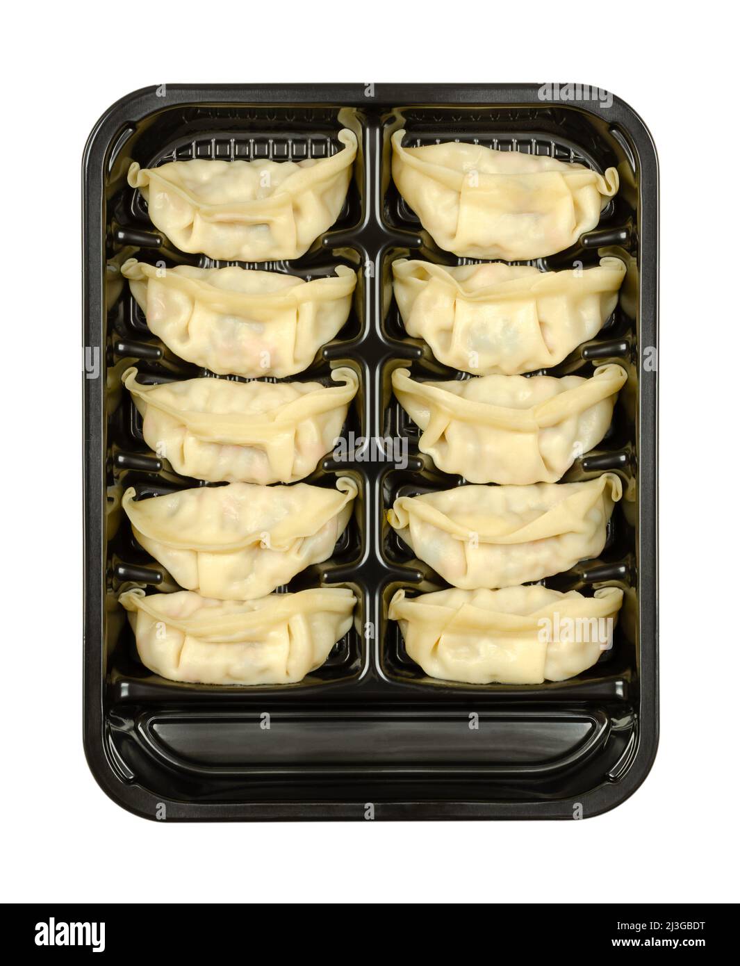 Gyoza, Japanese dumplings, in a black plastic tray. Uncooked, filled dumplings, ready to boil or fry. Filling, wrapped in thin batter. Stock Photo