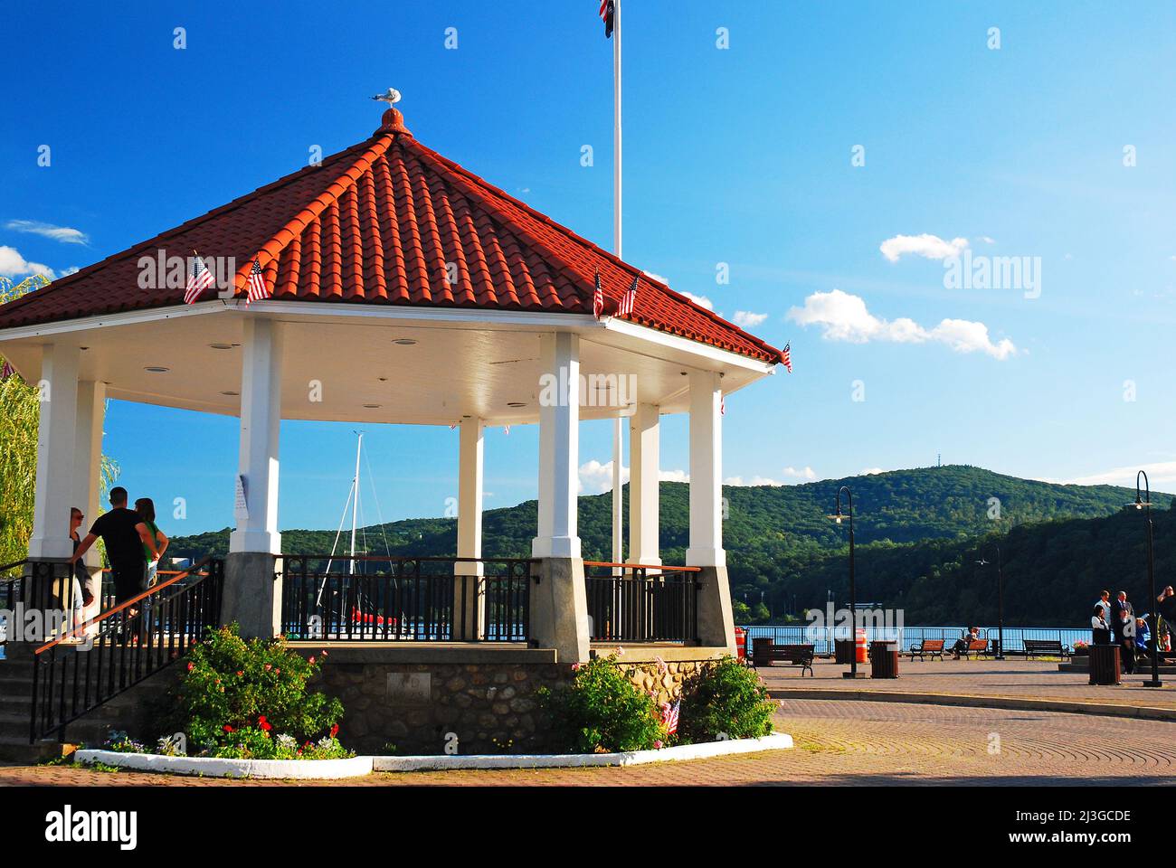 Red Tiled Gazebo sits on a small pier jutting into the Hudson River on a summer day Stock Photo