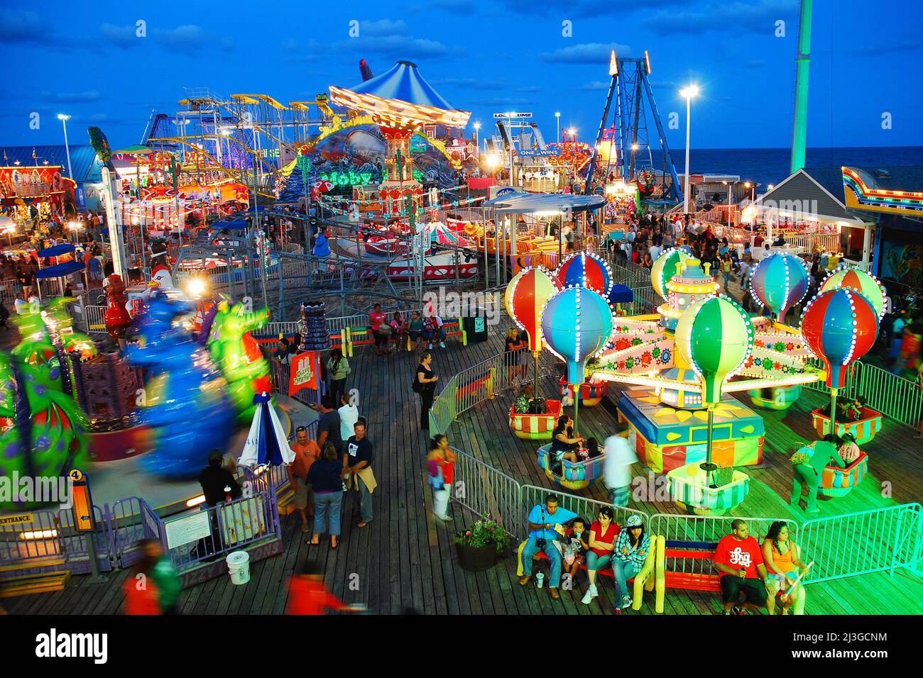 A summer vacation crowd enjoys the rides on the boardwalk in Seaside Heights on the Jersey Shore Stock Photo