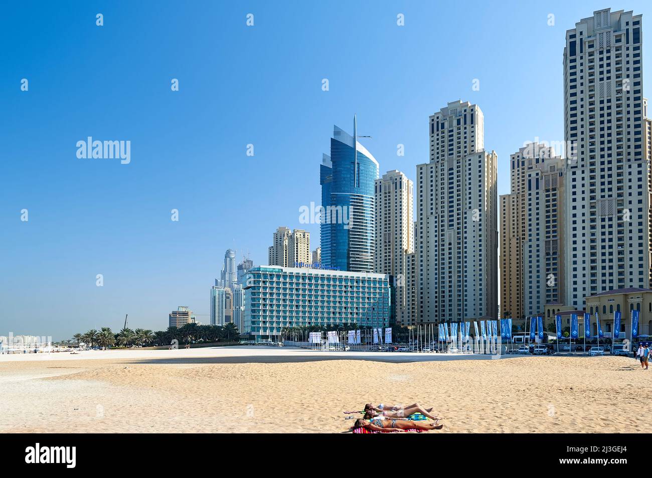 Dubai. UAE. Sunbathers at Dubai Marina Stock Photo