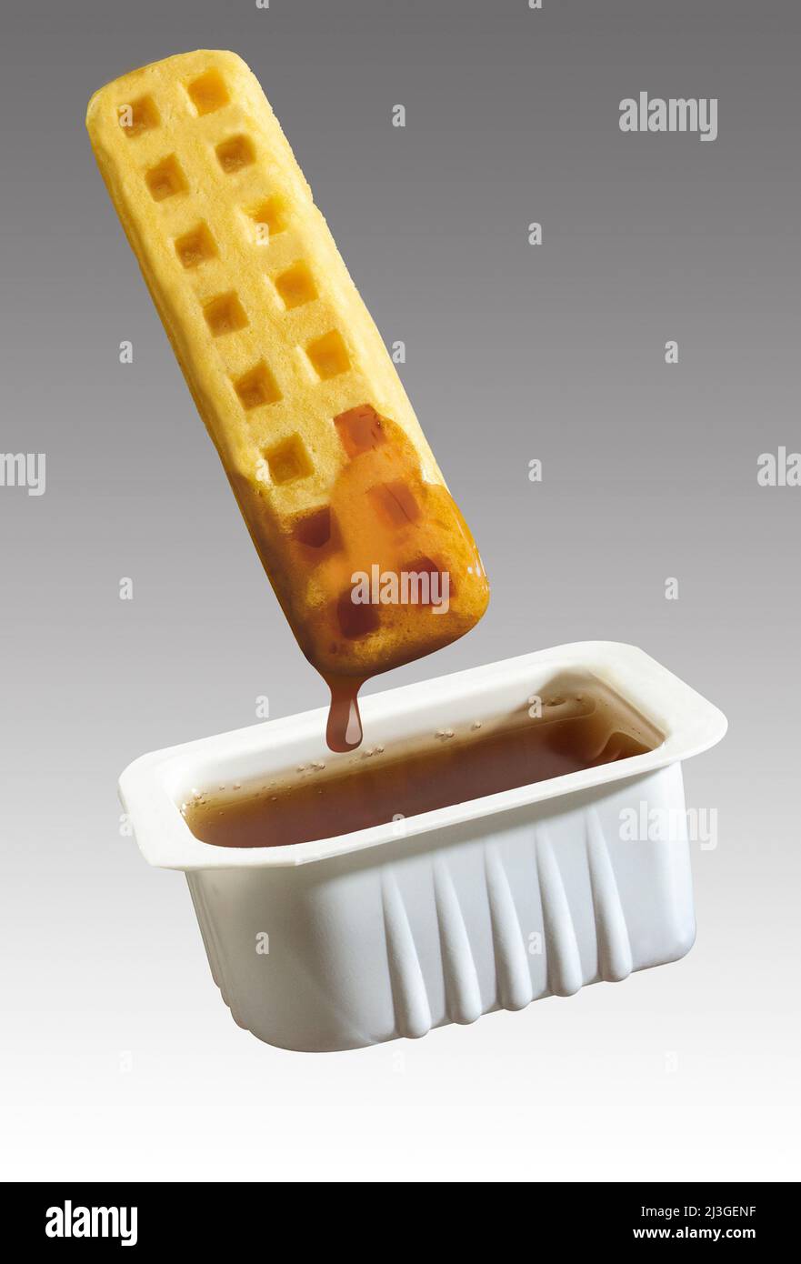 waffle stick dipped in syrup Stock Photo
