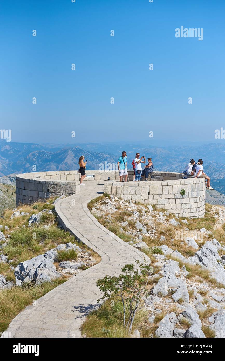 CETINJE, MONTENEGRO - JULY 23, 2021: A group of tourists in the viewpoint of Lovcen National Park Stock Photo