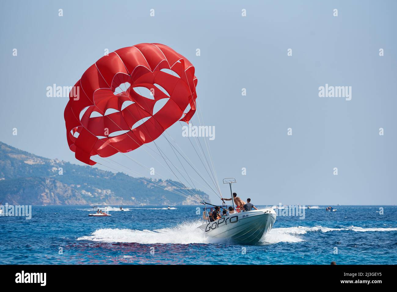 BUDVA, MONTENEGRO - JULY 22, 2021: Boat for parasailing tourists in the resort town Stock Photo