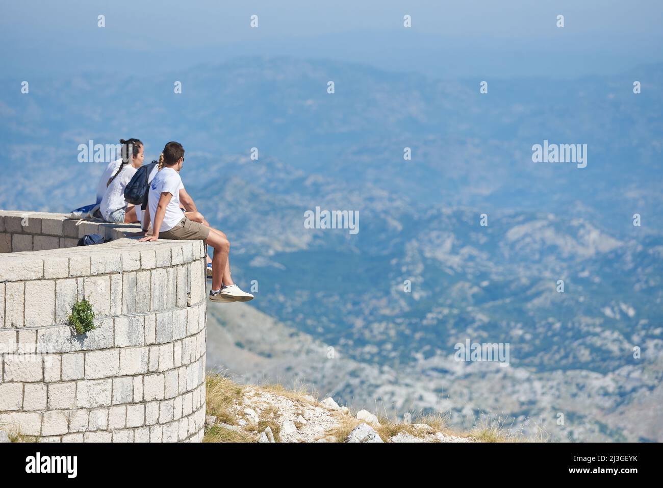 CETINJE, MONTENEGRO - JULY 23, 2021: A group of tourists look at the mountains of Lovcen National Park Stock Photo