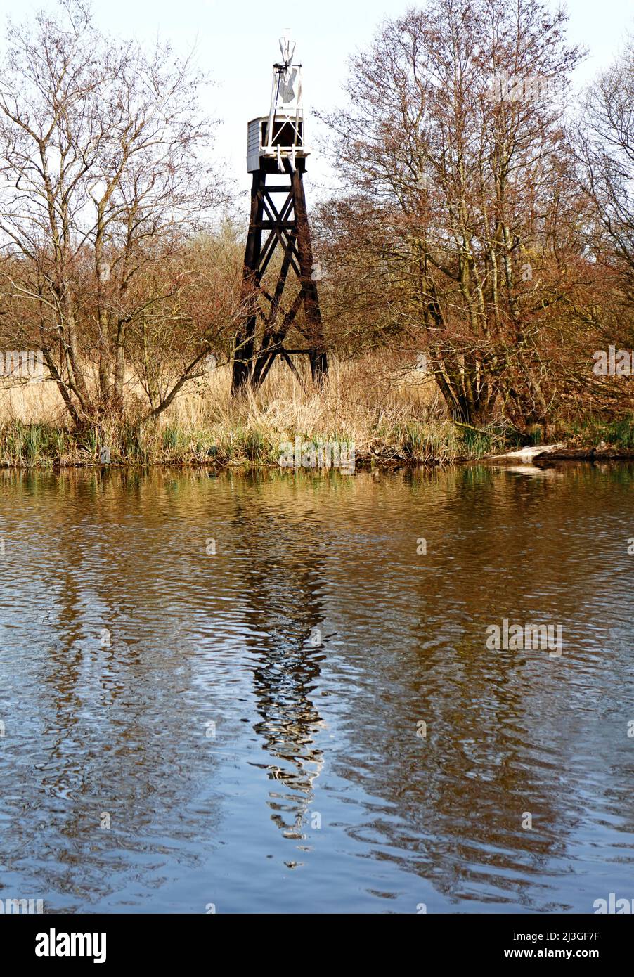 A view of the Hobb's Drainage Pump open trestle drainage mill by the River Bure on the Norfolk Broads at Horning, Norfolk, England, United Kingdom. Stock Photo