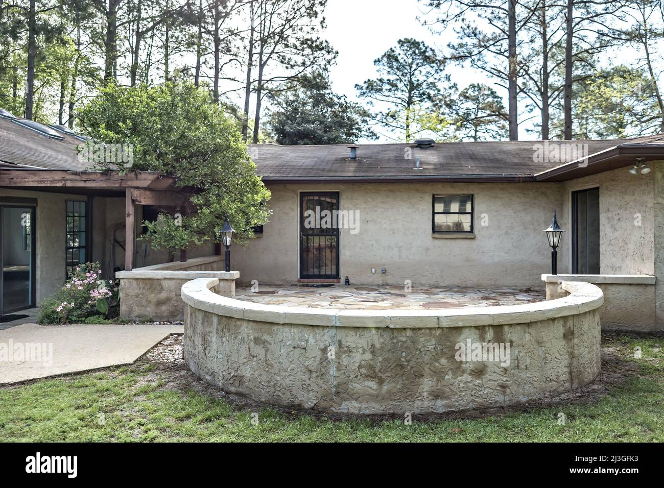 Rear side view of brown spanish style stucco and cinder block 1970's
