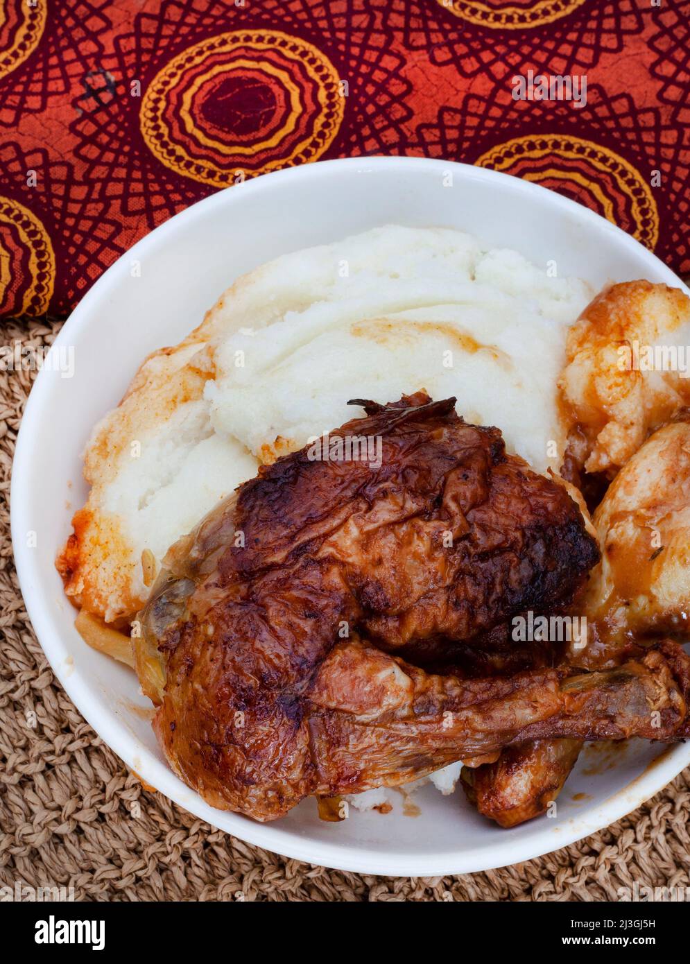 Traditional south African pap and quarter chicken, maize meal with roast chicken Stock Photo