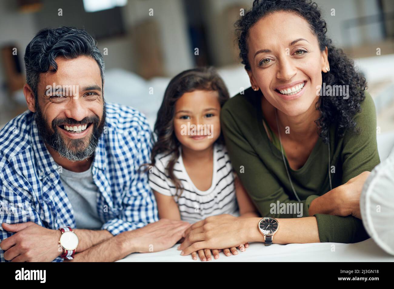 The best moments are shared as a family. Portrait of a happy family bonding together at home. Stock Photo