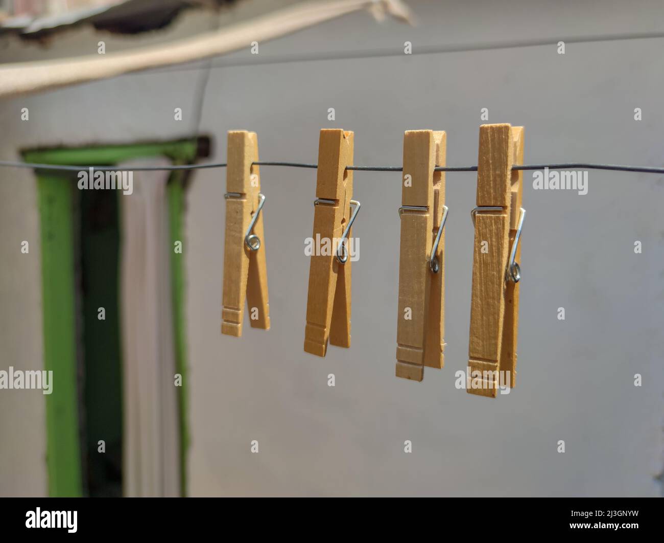 Clothes pins hanging on a wire Stock Photo Alamy