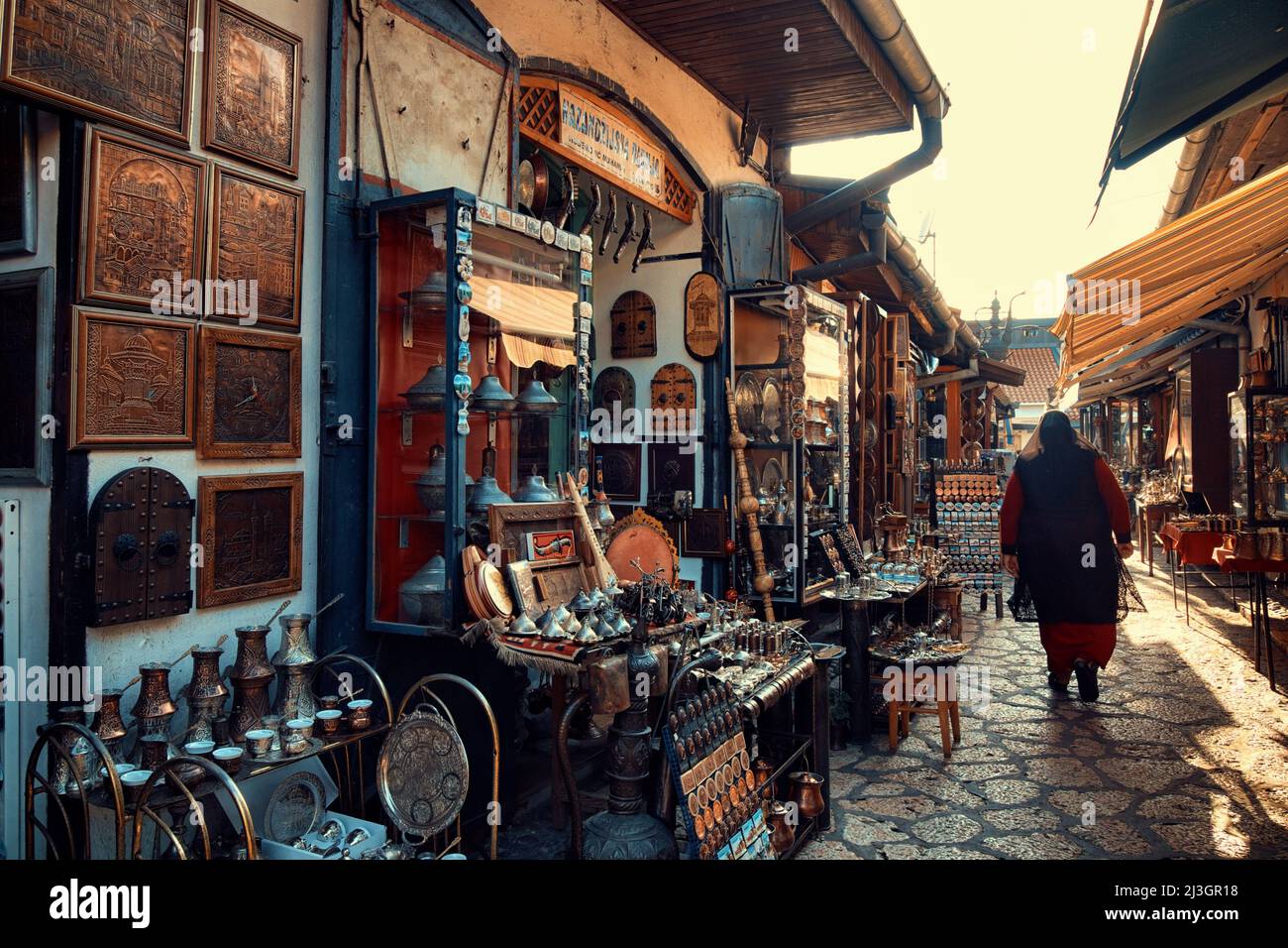 SARAJEVO, BOSNIA AND HERZEGOVINA - JULY 14, 2018: muslim woman walking in Old Sarajevo street bazaar Stock Photo