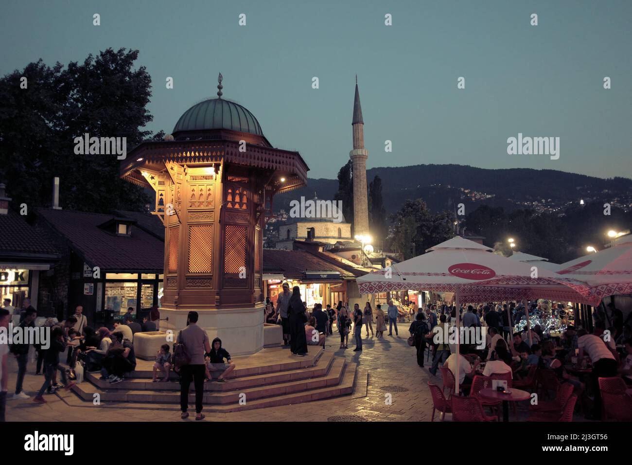 SARAJEVO, BOSNIA AND HERZEGOVINA - JULY 14, 2018: tourists in the square of Sebilj wooden fountain in the centre of Bascarsija at the twilight Stock Photo