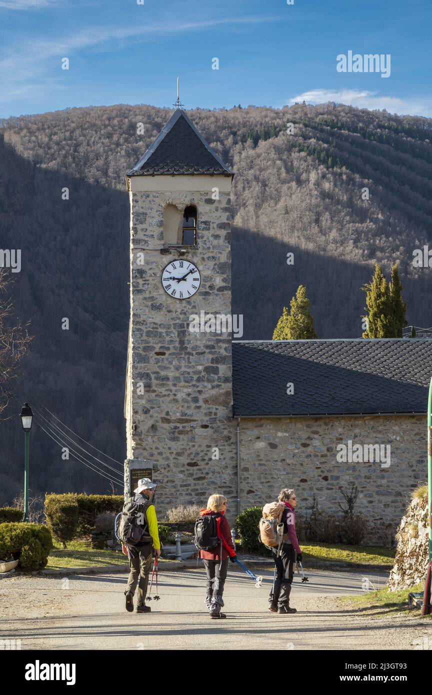 France, Ariege, Pyrenees massif, Tarascon sur Ariege, the church of Genat, departure of hikes and 3 hikers Stock Photo