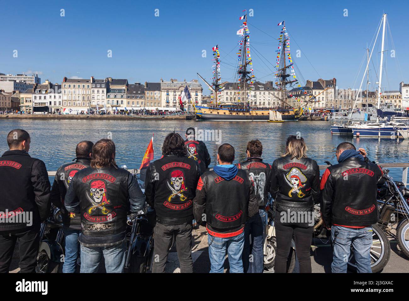 France, Manche, Cotentin, Cherbourg-Octeville, a group of bikers in black leather jackets admire frigate Hermione docked in Bassin du Commerce Stock Photo