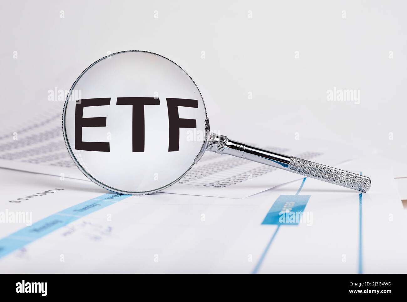 ETF word in magnifying glass. Investment, finance, business and stock market trading concept. Exchange-traded fund. Risks analysis and making money. High quality photo Stock Photo