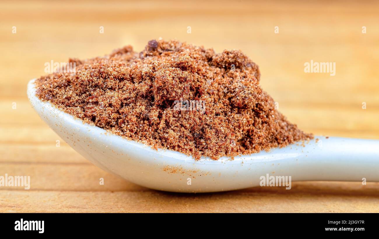 Ground food ingredient in a white spoon, macro Stock Photo