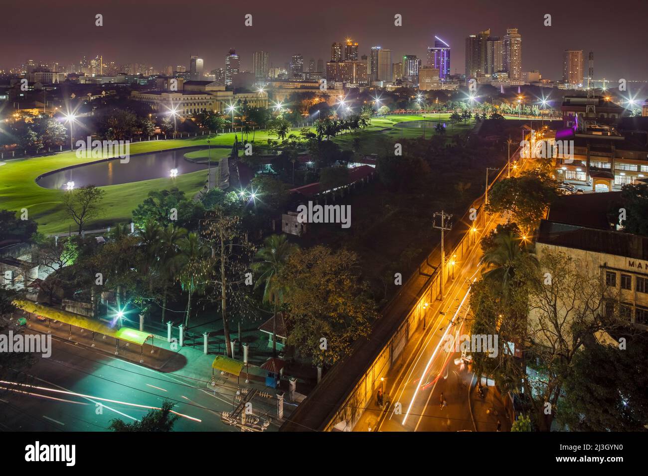 Philippines, Metro Manila, Intramuros, view from the Bayleaf Hotel, elevated view of Club Intramuros Golf Course, illuminated at night Stock Photo